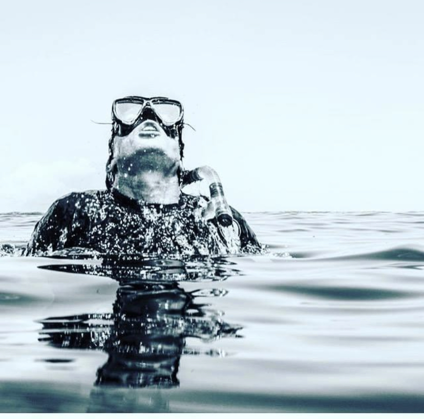 Captain Dane Karcher surfacing from a free dive with spear gun